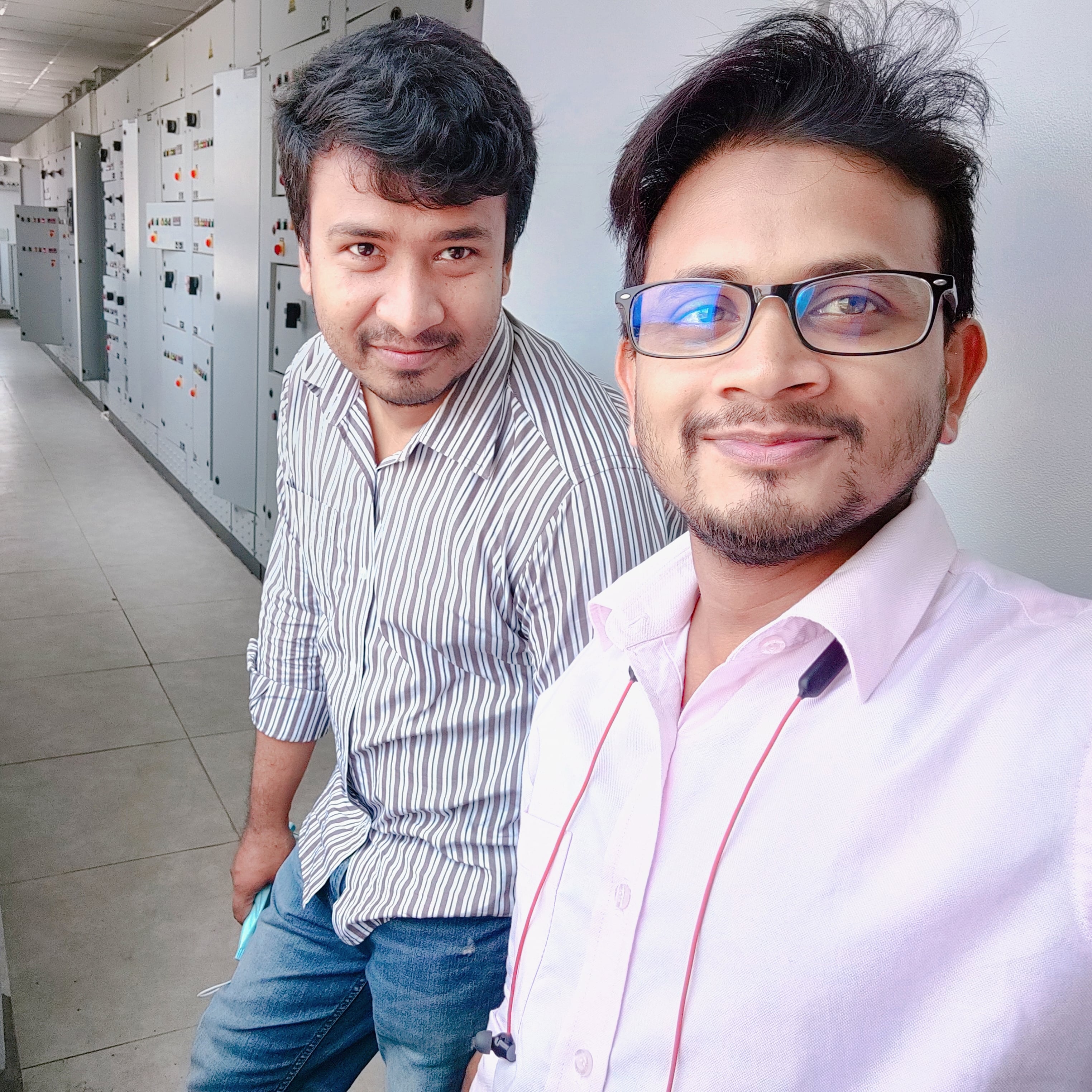 Reviewing switchgear and control panels with a colleague